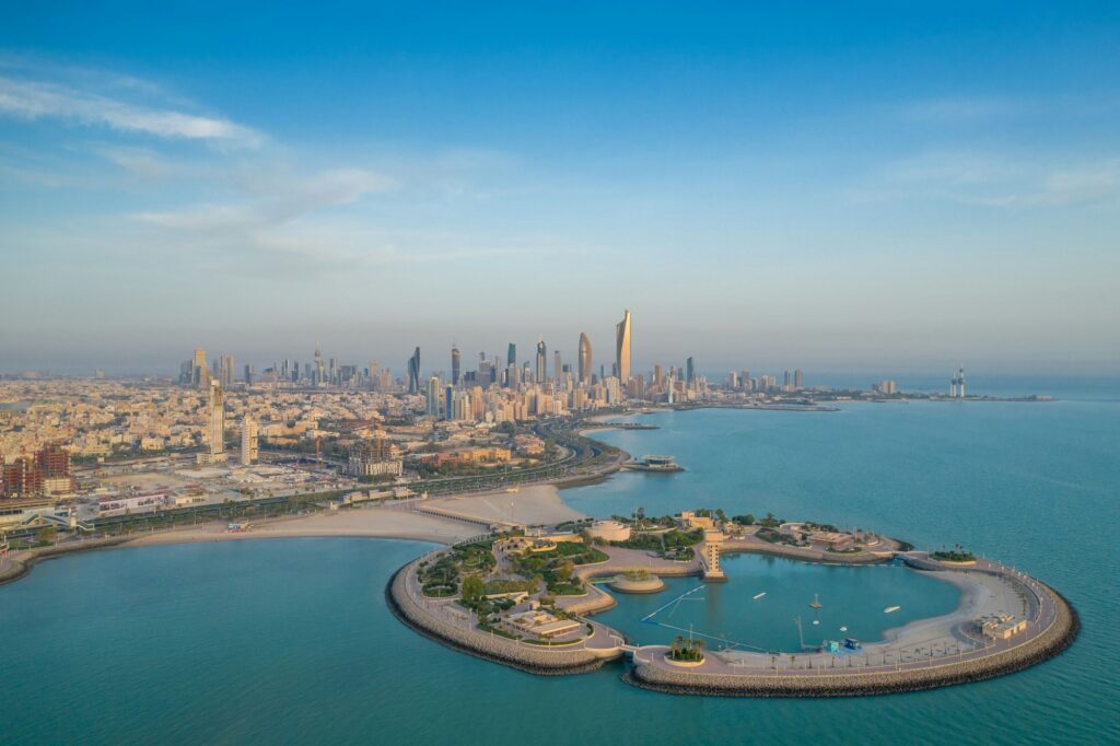 High-angle shot of The Green Island with a skyline of the city of Kuwait in the background